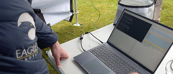 Image of person using a laptop to complete a drone consultancy task.