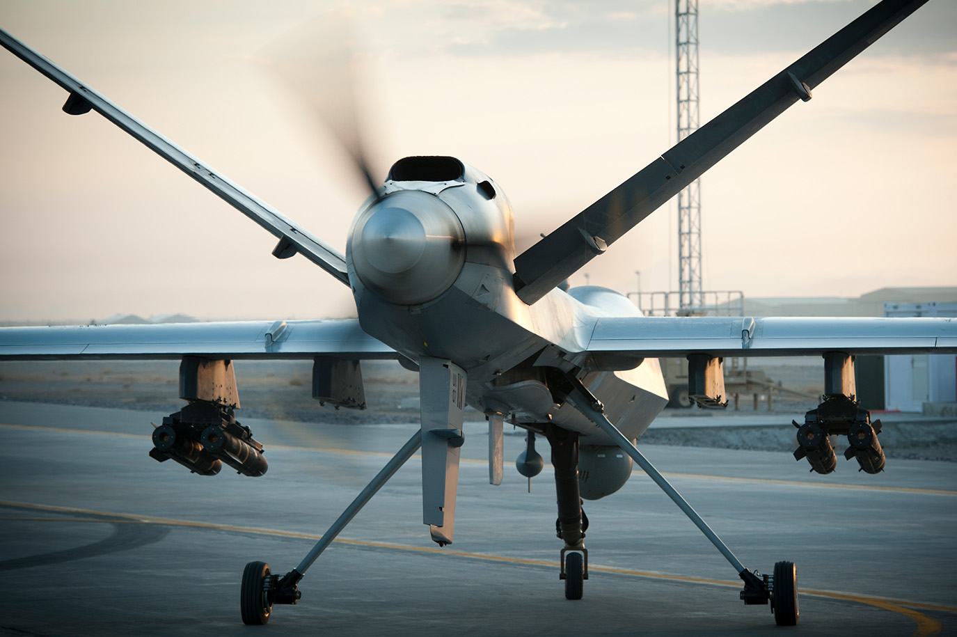 Image of a MQ-9 Reaper facing forward with propellors turning.