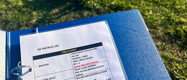 Image showing pre-flight checks for a Matrice 30T drone in a blue folder.