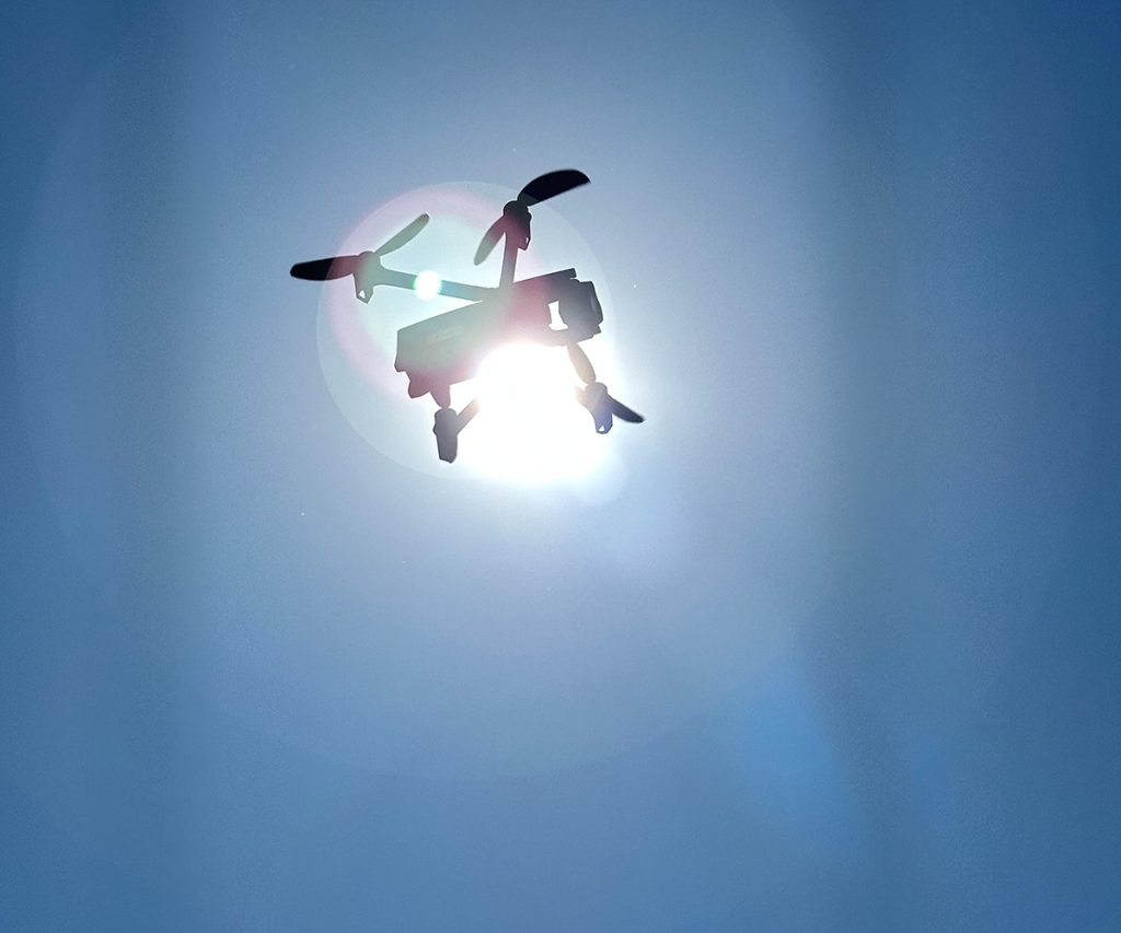 Parrot Anafi USA drone in front of sunlight against a blue sky