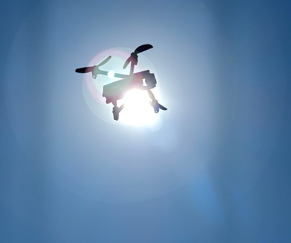 Parrot Anafi USA drone in front of sunlight against a blue sky