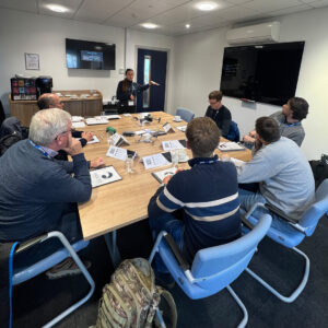 Students in a classroom being taught by a female instructor for RPC L1 training.